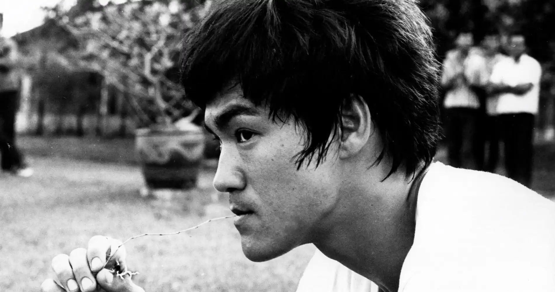 Black and white profile portrait showing a contemplative expression and distinctive short dark hair.