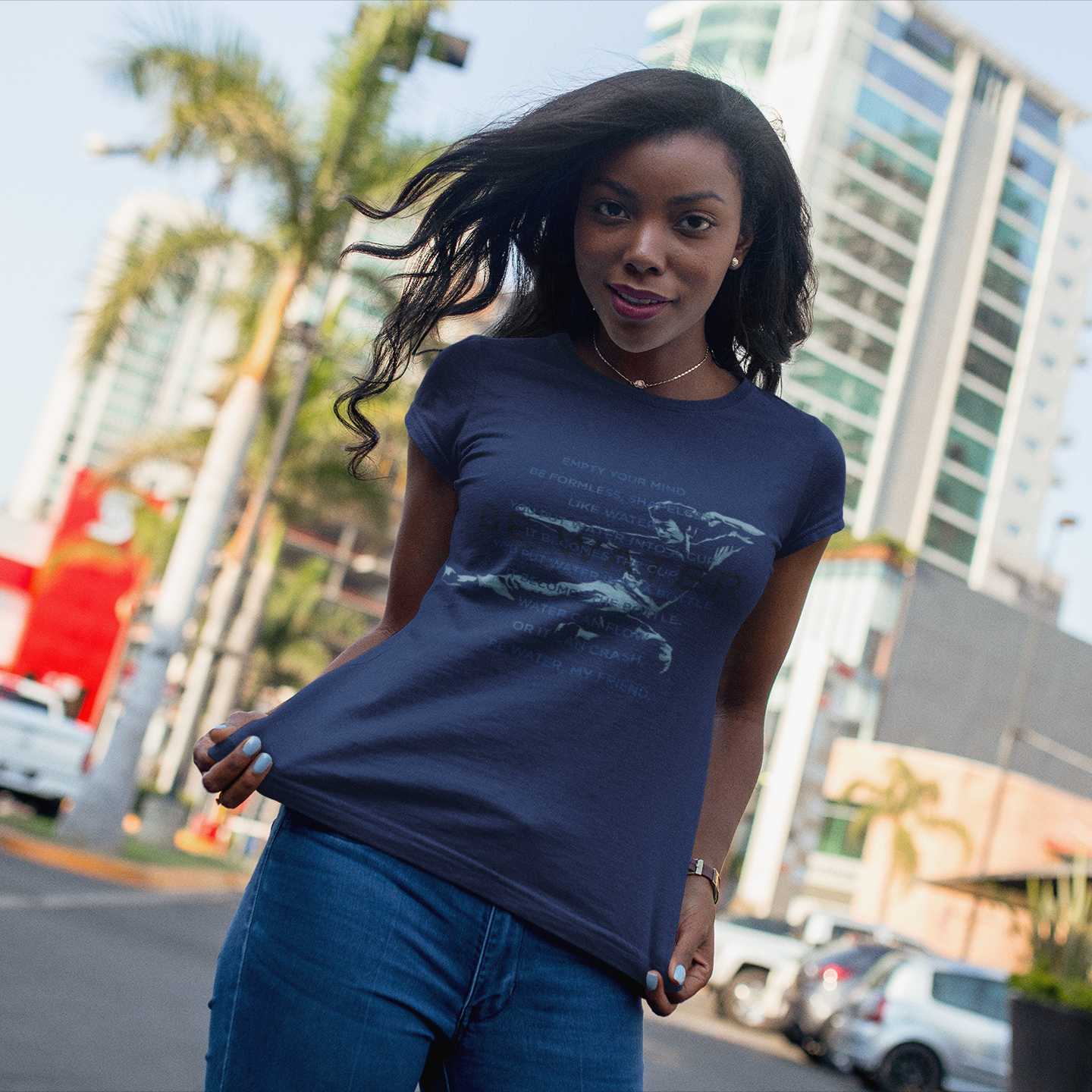 Woman in navy blue Be Water Painted Flying Man T-Shirt with graphic design