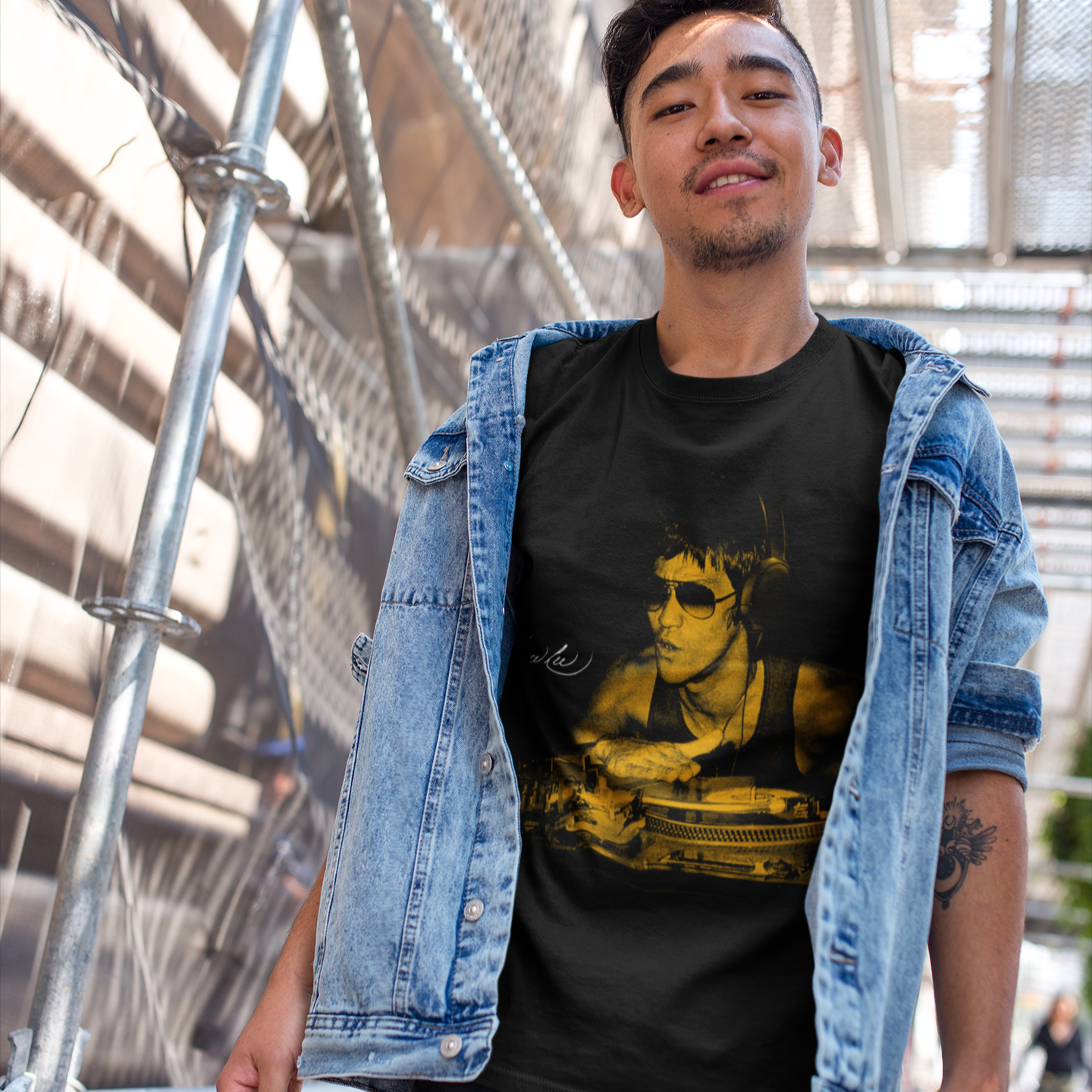 Man in denim jacket over Bruce Gold T-Shirt featuring iconic Bruce Lee graphic