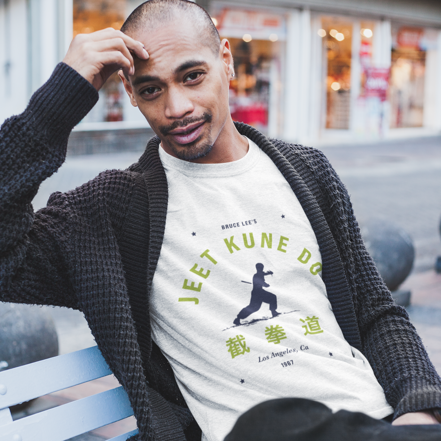 Man in a white Jeet Kune Do t-shirt showcasing Bruce Lee’s martial arts philosophy